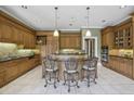 Well-equipped kitchen with custom cabinets, an island with seating, and stainless appliances at 5010 Heardmont Trace Rd, Cumming, GA 30028