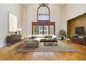 Bright living room with cathedral ceilings, hardwood floors, and large windows at 5010 Heardmont Trace Rd, Cumming, GA 30028