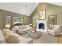Cozy living room with a fireplace, large windows, and comfortable seating at 5010 Heardmont Trace Rd, Cumming, GA 30028