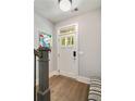 Bright entryway features a stylish front door, elegant hardwood floors, and modern decor at 986 Mauldin Se St, Atlanta, GA 30316