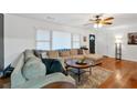 Bright living room with hardwood floors, comfortable seating, and a large window at 115 Pine Tree Dr, Fayetteville, GA 30214