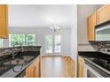 Bright kitchen featuring granite countertops, stainless steel appliances, and hardwood floors at 1150 Collier Nw Rd # 1N, Atlanta, GA 30318