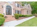 Charming front entrance with decorative glass doors and meticulously maintained landscaping at 1180 Oxford Dr, Conyers, GA 30013