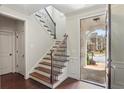 Inviting foyer featuring hardwood floors, staircase with decorative iron railings and trim at 425 Hunt Ne St, Marietta, GA 30060