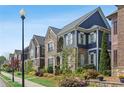 View of a charming home with stone and blue siding along a well-landscaped street with sidewalk at 425 Hunt Ne St, Marietta, GA 30060