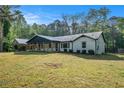 Beautiful exterior view of the home with a metal roof, front porch, and well-maintained lawn at 5035 Villa Rica Hwy, Dallas, GA 30157