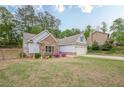 Beautiful home with a stone accent and landscaped garden for enhanced curb appeal at 549 Greenridge Ln, Loganville, GA 30052