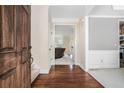 Inviting foyer with hardwood floors, a view of the living room, and access to the kitchen at 1057 Cotton Oak Dr, Lawrenceville, GA 30045
