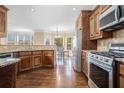 Well-lit kitchen with stainless steel appliances, granite countertops, and a breakfast area at 1057 Cotton Oak Dr, Lawrenceville, GA 30045