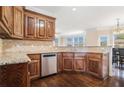 Kitchen features wood cabinetry, stainless steel appliances, granite countertops, and a breakfast nook at 1057 Cotton Oak Dr, Lawrenceville, GA 30045