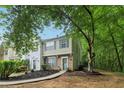 Inviting townhouse exterior with manicured lawn, brick accents, and mature trees at 3618 Berkeley Ct # Iv-A, Duluth, GA 30096