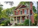 Lovely two-story home with a red exterior, a cozy front porch and chimney at 604 Mead Se St, Atlanta, GA 30312
