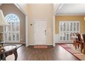 Inviting foyer with hardwood floors, a front door, and lots of natural light at 7010 Beloit Pl, Roswell, GA 30075