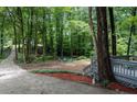 An outdoor seating area with mulch and trees provides a serene escape at 111 John Christopher Dr, Alpharetta, GA 30009