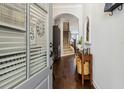 Inviting foyer with hardwood floors, staircase, console table, mirror, coat hooks and lots of natural light at 243 Retreat Ln, Canton, GA 30114