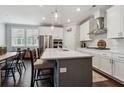 Bright, spacious kitchen featuring white cabinets, a large island, stainless steel appliances, and hardwood floors at 243 Retreat Ln, Canton, GA 30114