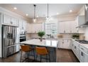 Modern kitchen with stainless steel appliances, a central island with seating, and ample counter space at 2467 Davis Se Dr, Smyrna, GA 30080