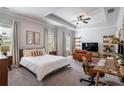 Spacious main bedroom with a tray ceiling, plush carpeting, and abundant natural light, offering a serene retreat at 2467 Davis Se Dr, Smyrna, GA 30080