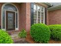 Close up of brick home with decorative windows and lush landscaping at 5510 Conway Dr, Marietta, GA 30068