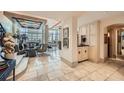 Elegant living room featuring travertine floors, bar, and ample natural light at 147 15Th Ne St # 16C, Atlanta, GA 30309
