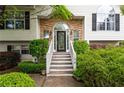 Inviting entryway with stone accents, a decorative front door, and manicured greenery leading up to the house at 174 Cannon Pl, Dallas, GA 30157
