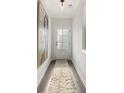 Bright hallway with a textured runner, neutral walls, and a stylish front door at 3747 Silvery Way, Powder Springs, GA 30127