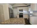 Bright kitchen with white cabinets, granite countertops, stainless appliances, and large kitchen island at 4185 Brookwood Dr, Austell, GA 30106