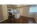 Spacious kitchen with island, white cabinets, stainless steel appliances, and hardwood flooring at 4185 Brookwood Dr, Austell, GA 30106