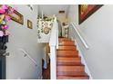 Inviting foyer featuring a staircase with wood steps, white risers, and decorative floral accents at 1010 Augusta Woods Dr, Douglasville, GA 30134