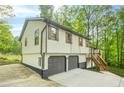 Charming home featuring a convenient two-car garage and inviting entryway staircase at 4316 Acuba Sw Ct, Lilburn, GA 30047