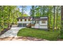 Charming home with a two-car garage, landscaped yard, and a delightful porch entrance at 4316 Acuba Sw Ct, Lilburn, GA 30047
