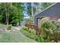Backyard lush garden and stone seating near the lake create a tranquil outdoor space at 2240 E Lake Ne Dr, Conyers, GA 30012