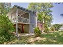 Exterior view of home with a spacious deck, lower-level access, and peaceful surroundings at 2240 E Lake Ne Dr, Conyers, GA 30012