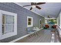 Covered porch featuring outdoor seating, ceiling fans, and views of the surrounding greenery at 2240 E Lake Ne Dr, Conyers, GA 30012