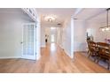 Bright entryway with hardwood floors, white trim, and a view into the adjacent dining room and living room at 3145 Maple Terrace Drive, Suwanee, GA 30024