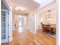 Bright entryway with hardwood floors, white trim, and a view into the adjacent dining room and living room at 3145 Maple Terrace Drive, Suwanee, GA 30024