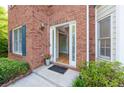 Inviting front entrance with a brick facade, classic door, and well-maintained landscaping at 3145 Maple Terrace Drive, Suwanee, GA 30024