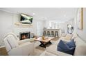 Cozy living room with a brick fireplace, hardwood floors, and ample seating at 3917 Plantation Dr, Marietta, GA 30062
