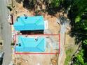 Aerial view of new homes under construction, with protective blue sheathing on the roofs at 11821 Serenbe Ln, Chattahoochee Hills, GA 30268