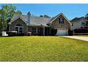 Beautiful brick home with a well-kept lawn, driveway, and lush landscaping at 20 Chapman Way, Covington, GA 30016