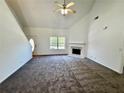 Spacious living room with a fireplace, carpeted floors, and ample natural light at 20 Chapman Way, Covington, GA 30016