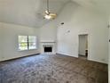 Bright living room featuring high ceilings, a fireplace, and large windows at 20 Chapman Way, Covington, GA 30016