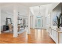Bright foyer with hardwood floors, columns, and an elegant glass-paneled front door at 1675 Bookhout Dr, Cumming, GA 30041