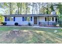 Inviting single-story home with a cozy front porch and well-manicured landscaping at 1824 Guardian Way, Lawrenceville, GA 30043