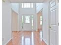 Bright foyer with hardwood floors, high ceilings, and a decorative glass front door at 2869 Hickory Run Cir, Duluth, GA 30096