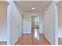 Hallway featuring hardwood floors, white walls, and multiple doorways leading to various rooms at 2869 Hickory Run Cir, Duluth, GA 30096