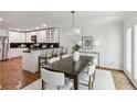 Open concept kitchen and dining area with stainless steel appliances and a modern chandelier at 3794 Ashford Lake Ne Ct, Brookhaven, GA 30319