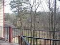 Enjoy the outdoor views from the balcony with steel rails, overlooking trees and landscape at 412 Hawkstone Way, Alpharetta, GA 30022