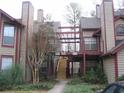 Condominium featuring wooden stairs, beams and attractive landscaping with low growing shrubs at 412 Hawkstone Way, Alpharetta, GA 30022