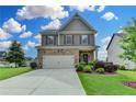 Charming two-story home with a mix of stone and siding, a well-kept lawn, and a driveway at 4215 Cordova Ln, Cumming, GA 30028